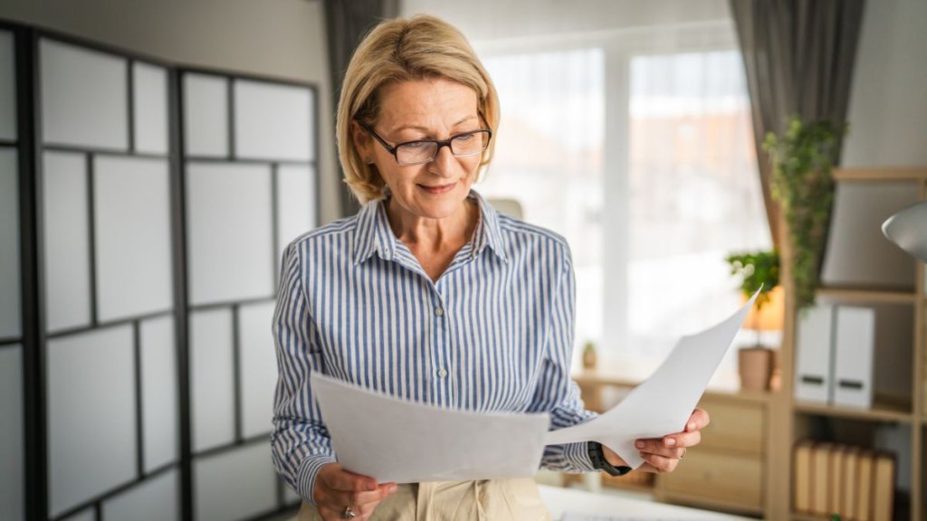 older women looking at papers