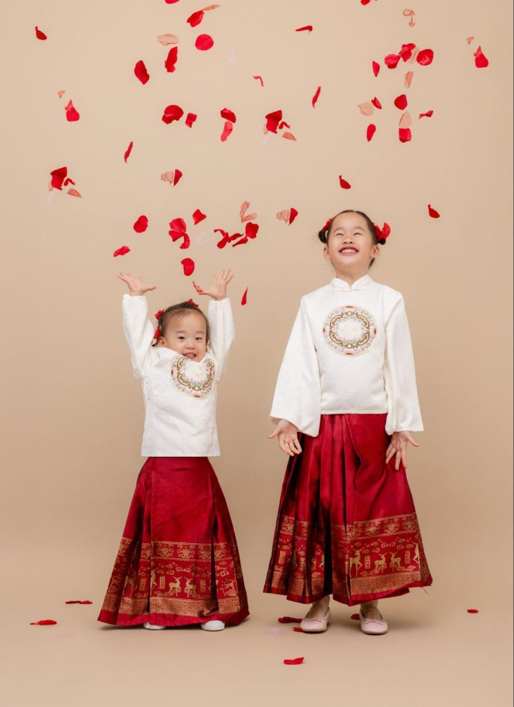 2 young girls throwing flowers in the air