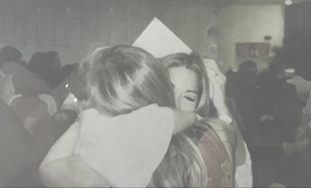 Ivelisse embracing our mom at her high school graduation
