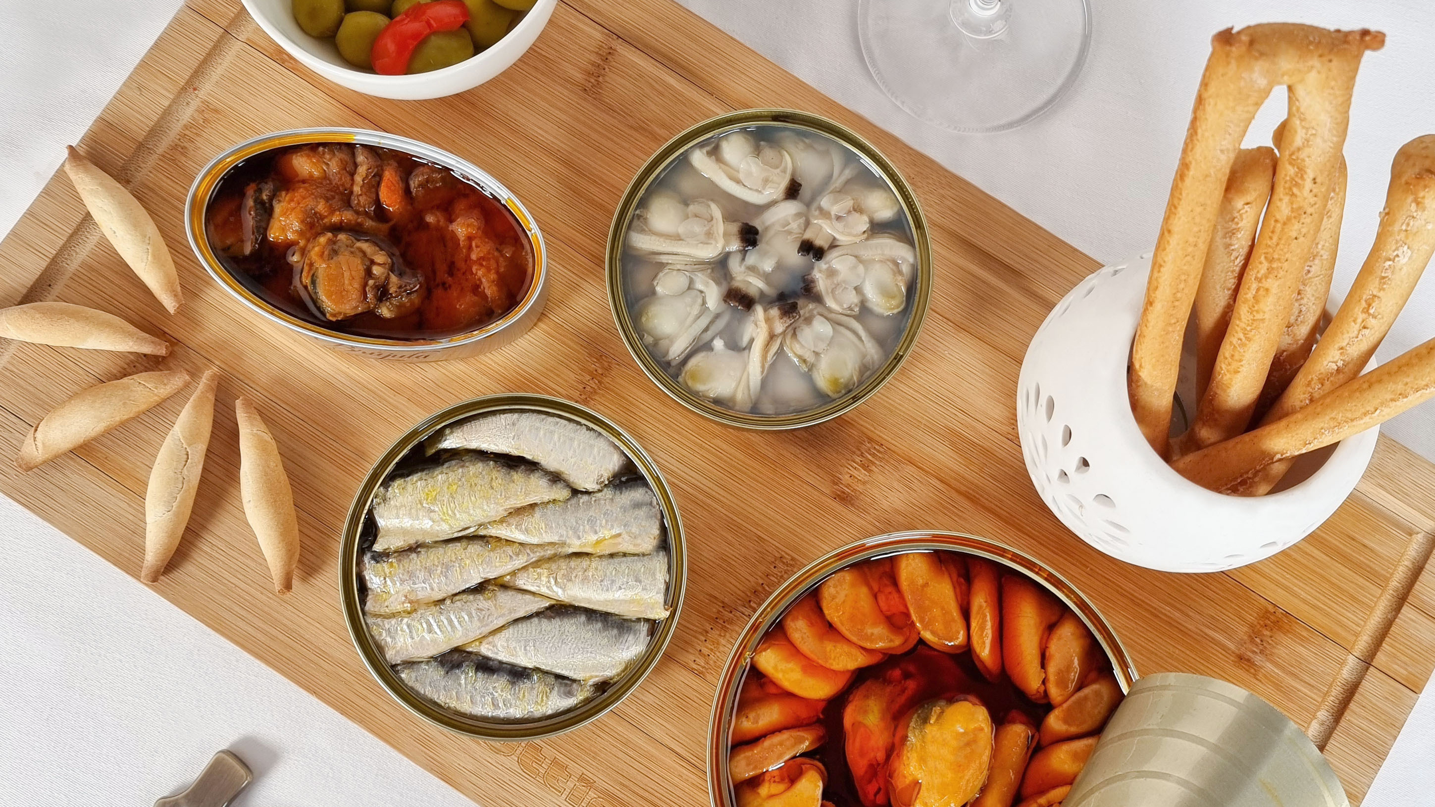 A cutting board with Spanish Conservas From Conservas La Brújula