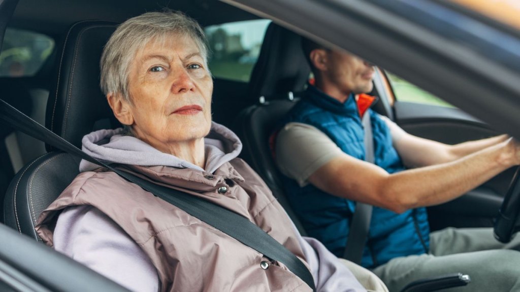 Elderly woman riding as passenger
