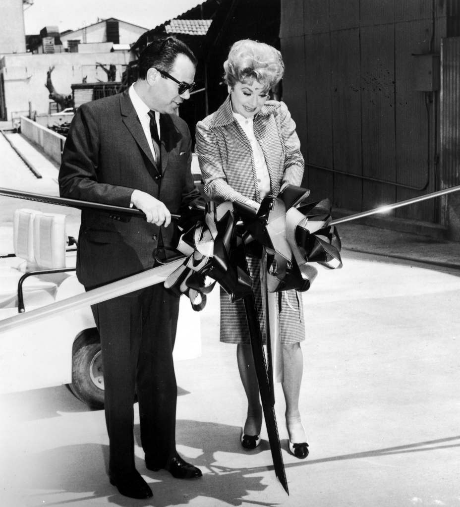Lucille Ball cuts a ribbon of 70mm film stock to represent the acquisition of her Hollywood production company Desilu by American conglomerate Gulf+Western, 1967. 