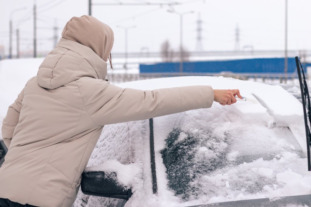 woman cleaning off car