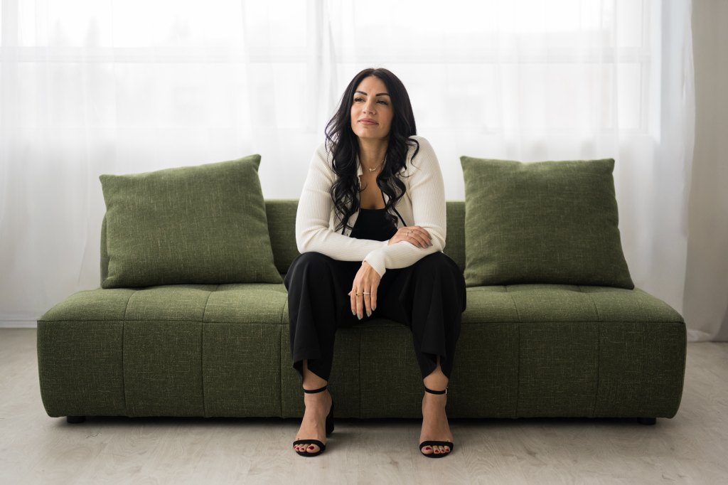 Tania Khazaal sitting on a sofa