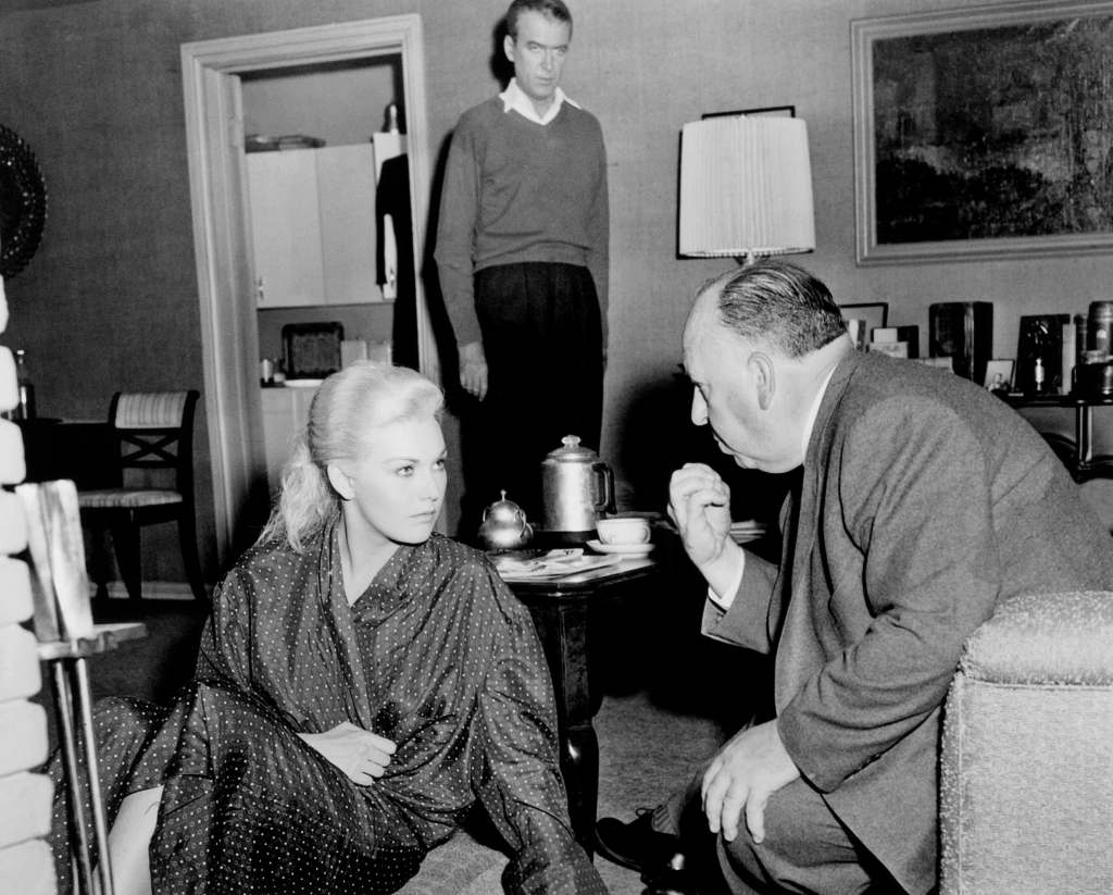 VERTIGO, from left, Kim Novak, James Stewart, director Alfred Hitchcock, on-set, 1958
