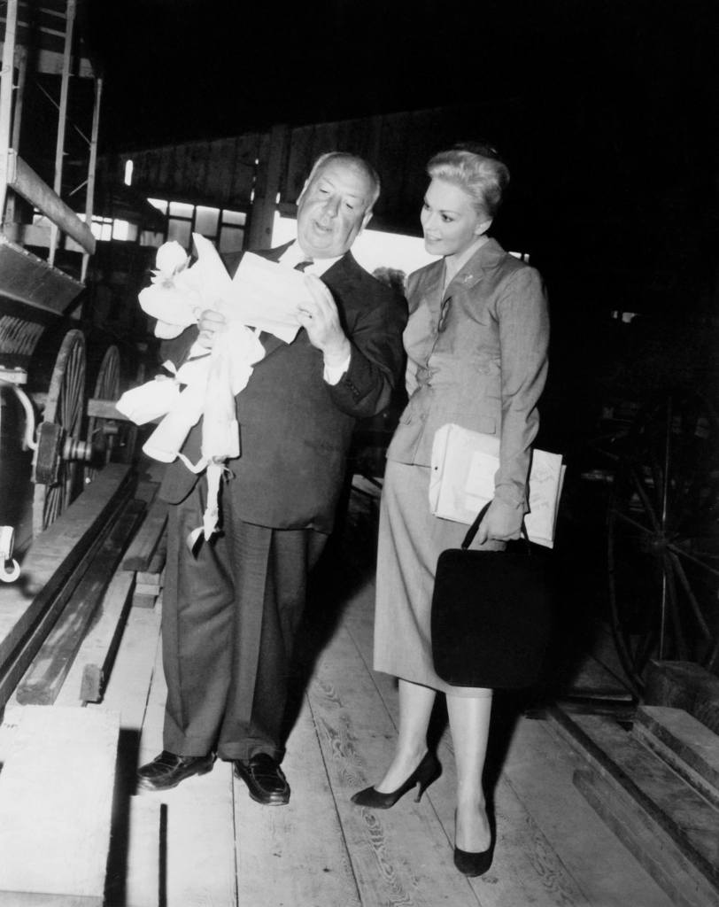 VERTIGO, director Alfred Hitchcock, Kim Novak, between scenes, 1958