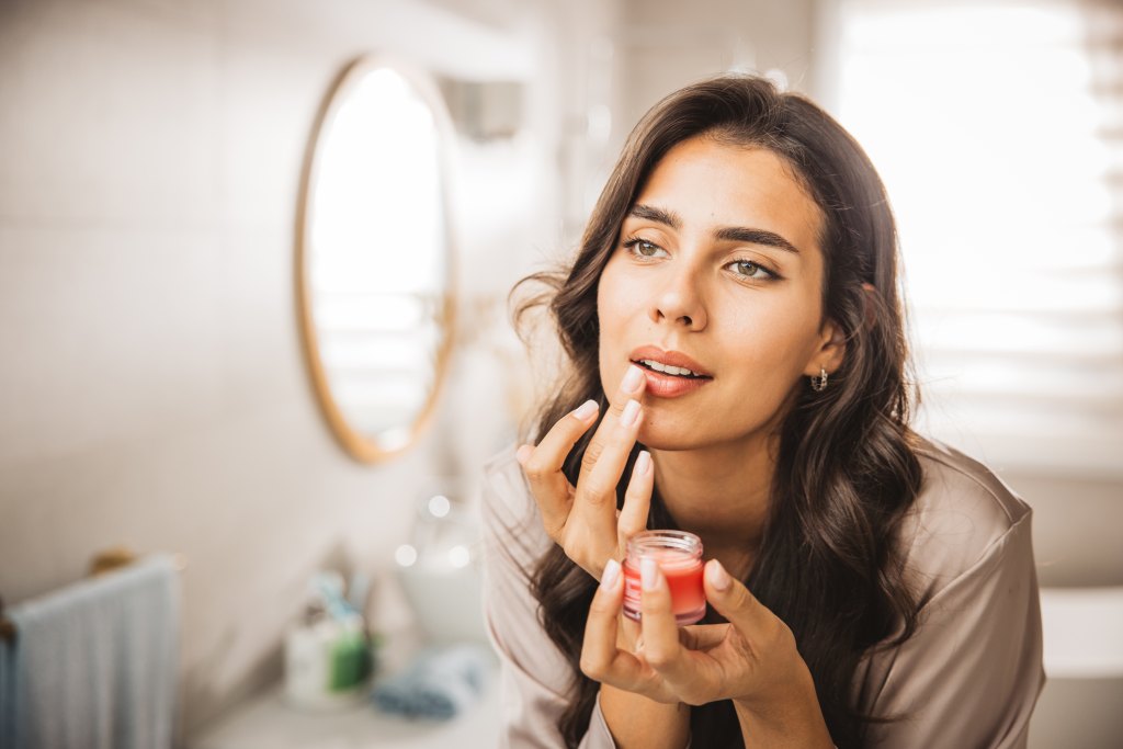 woman applying lip balm