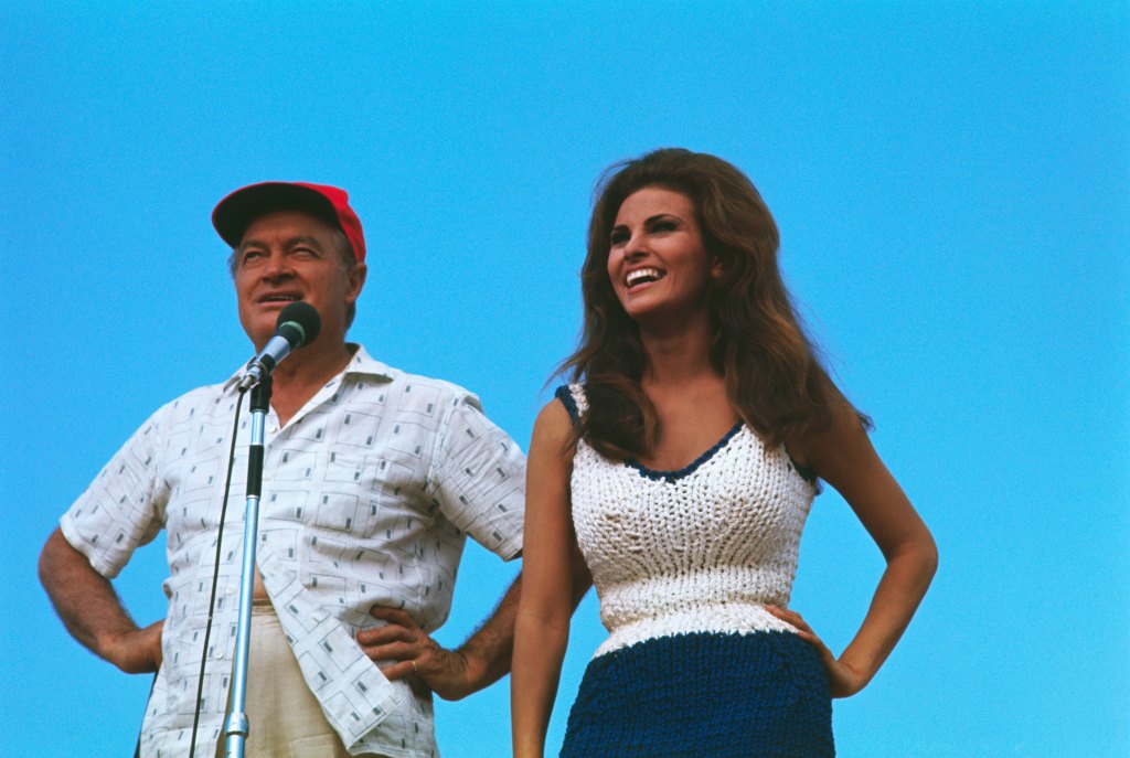 (Original Caption) Comedian Bob Hope and actress Raquel Welch enertain troops at an unidentified outdoor site in Vietnam.