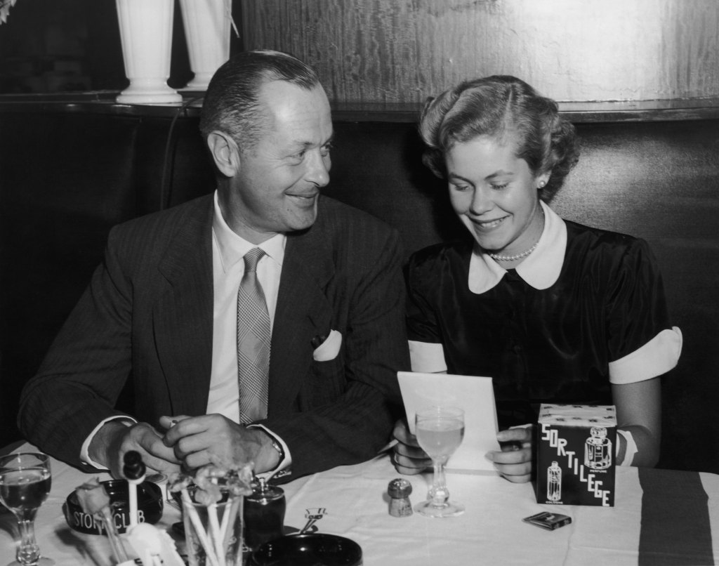 American actor Robert Montgomery (1904 - 1981) dines with his daughter, actress Elizabeth Montgomery (1933 - 1995), at the Stork Club in New York City, circa 1955.