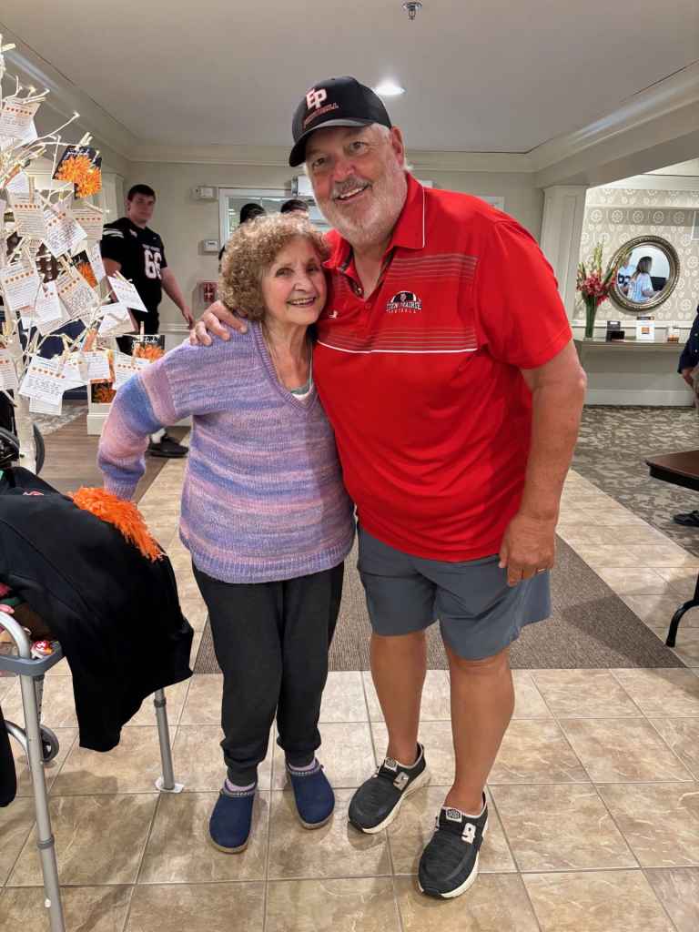 Coach Mike Grant (right) with resident, Roberta, who was his neighbor growing up