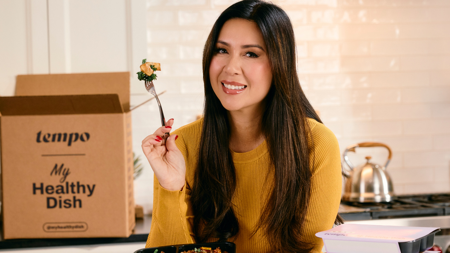 My Nguyen poses with a box of her Tempo meals
