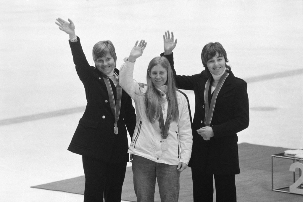 U.S. gold medalist Barbara Cochran (center), French silver medalist Danielle Debernard (right) and French bronze medalist Florence Steurer (left) wave on the podium of the Women's slalom during the Winter Olympics on February 11, 1972 in Sapporo