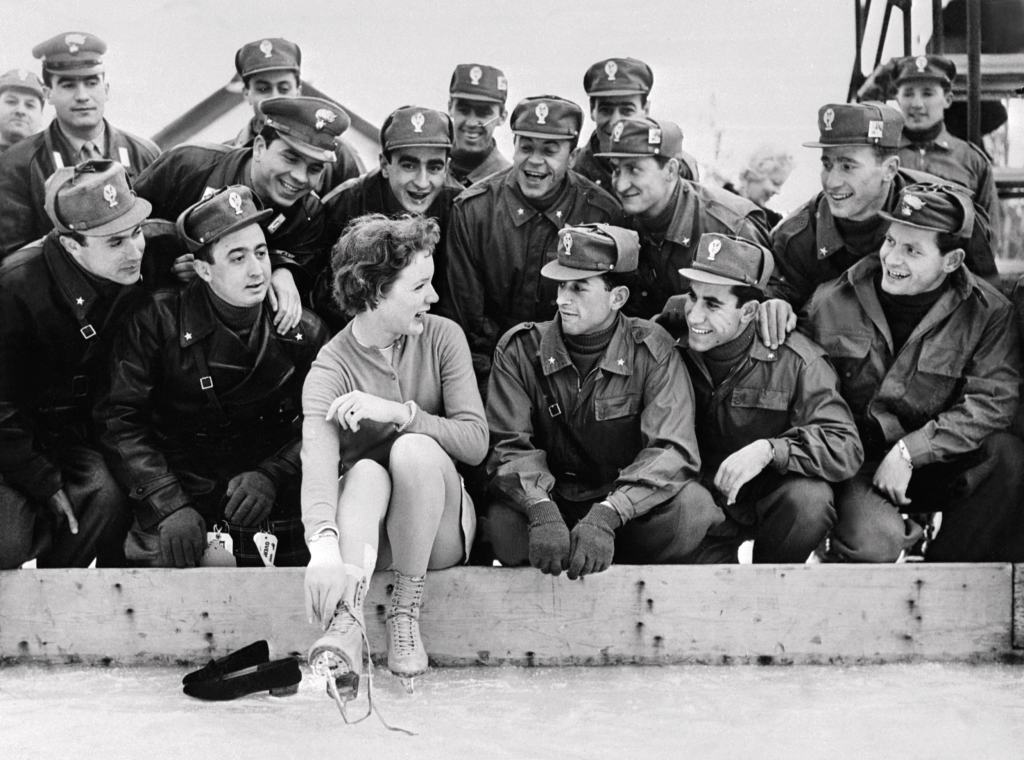 Tenley Albright poses with Italian soldiers at the 1956 Winter Olympics