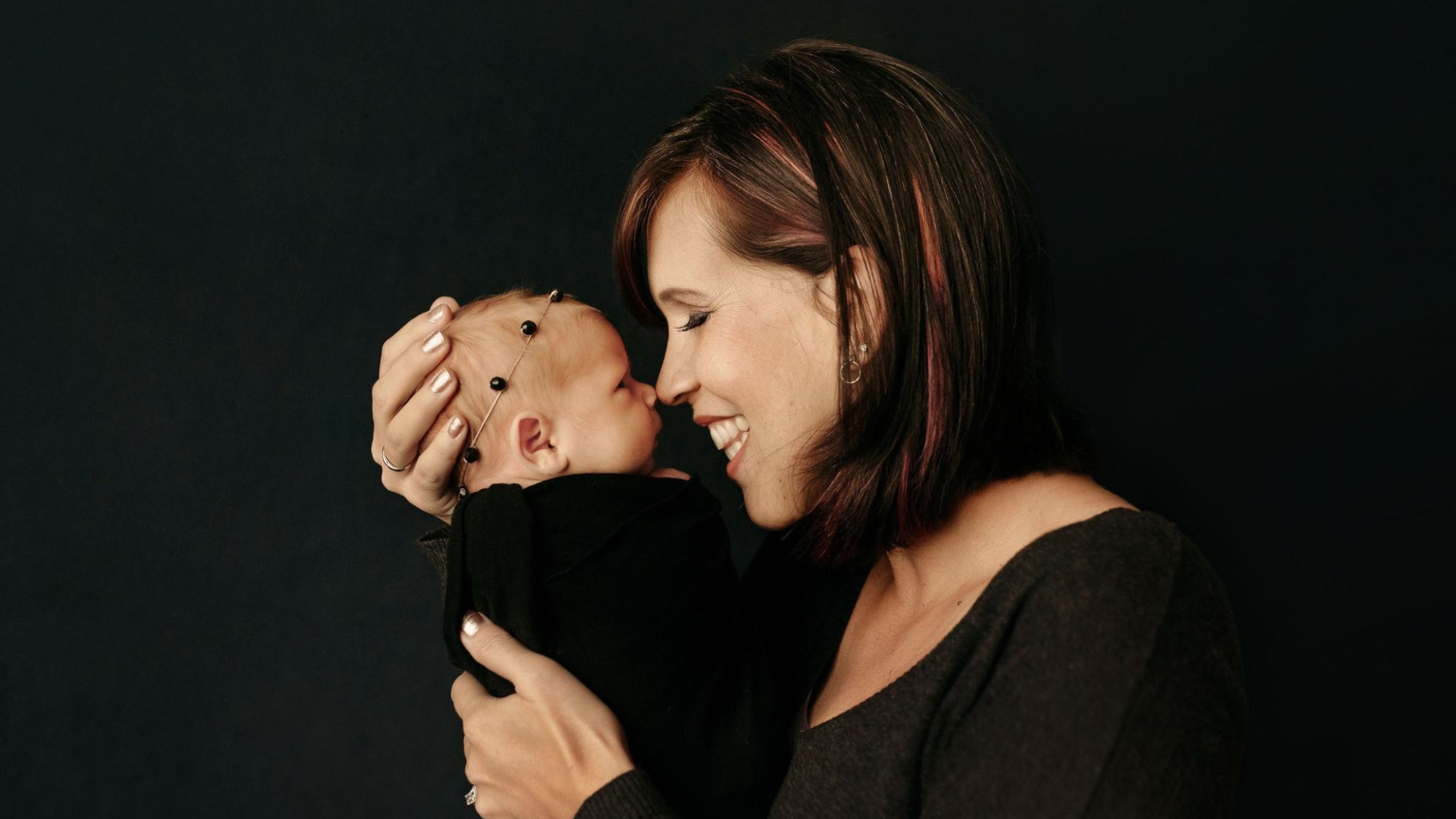 Tina Sixberry portrait holding her baby Gemma