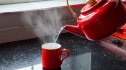 Close-up of hot water being poured into a mug to drink
