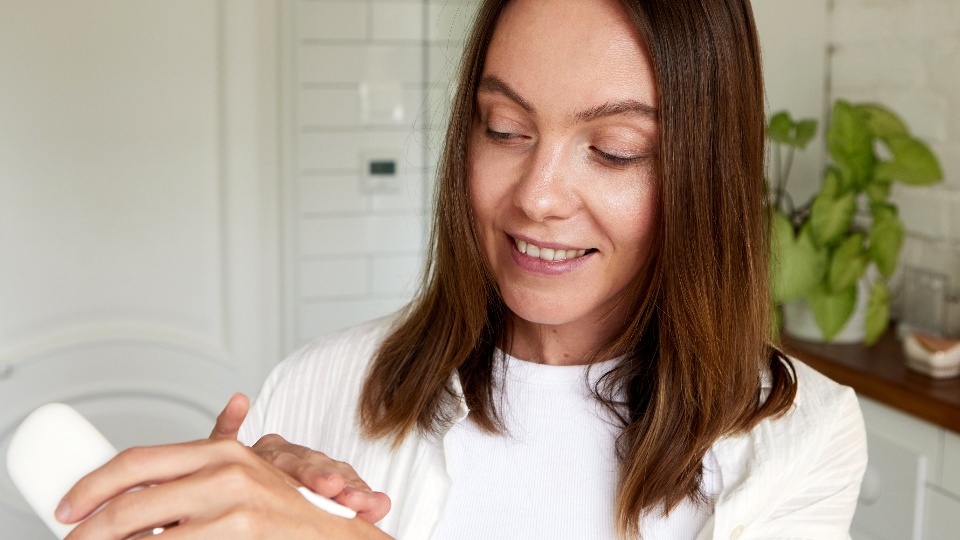 Woman applying hand cream