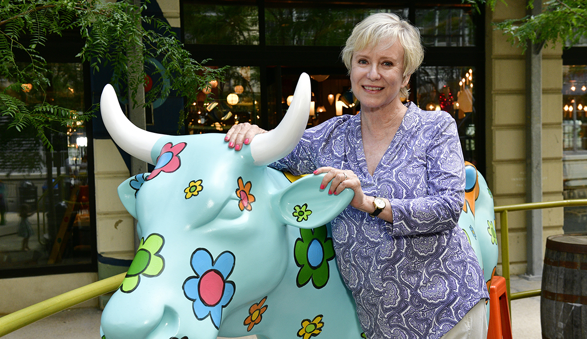 Artist Eve Plumb poses with her "Daisy" painted cow on display at the CowParade 2021 launch event hosted by God’s Love We Deliver at the Artist Studio sponsored by CLEAR in Industry City on August 5, 2021 in Brooklyn, NY.