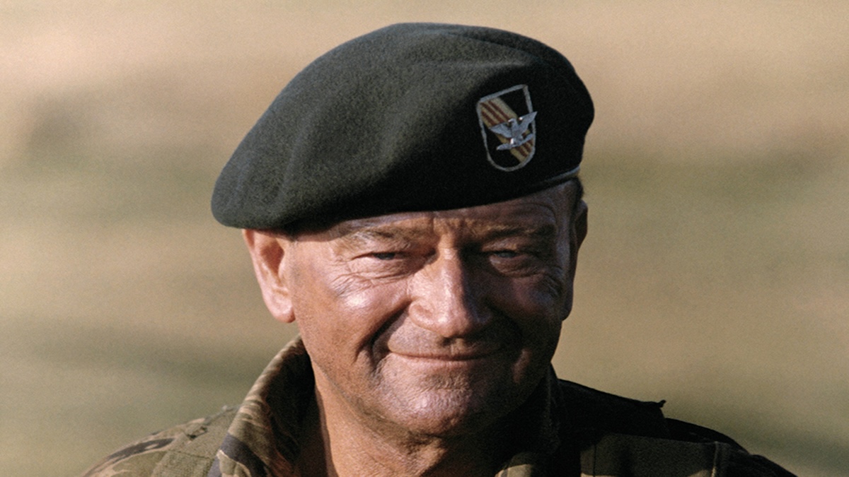 John Wayne smiling wearing his combat uniform in a portrait for his 1968 Vietnam war movie The Green Berets.