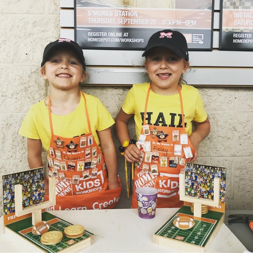 The sisters proudly show off one of their DIY projects at Home Depot.