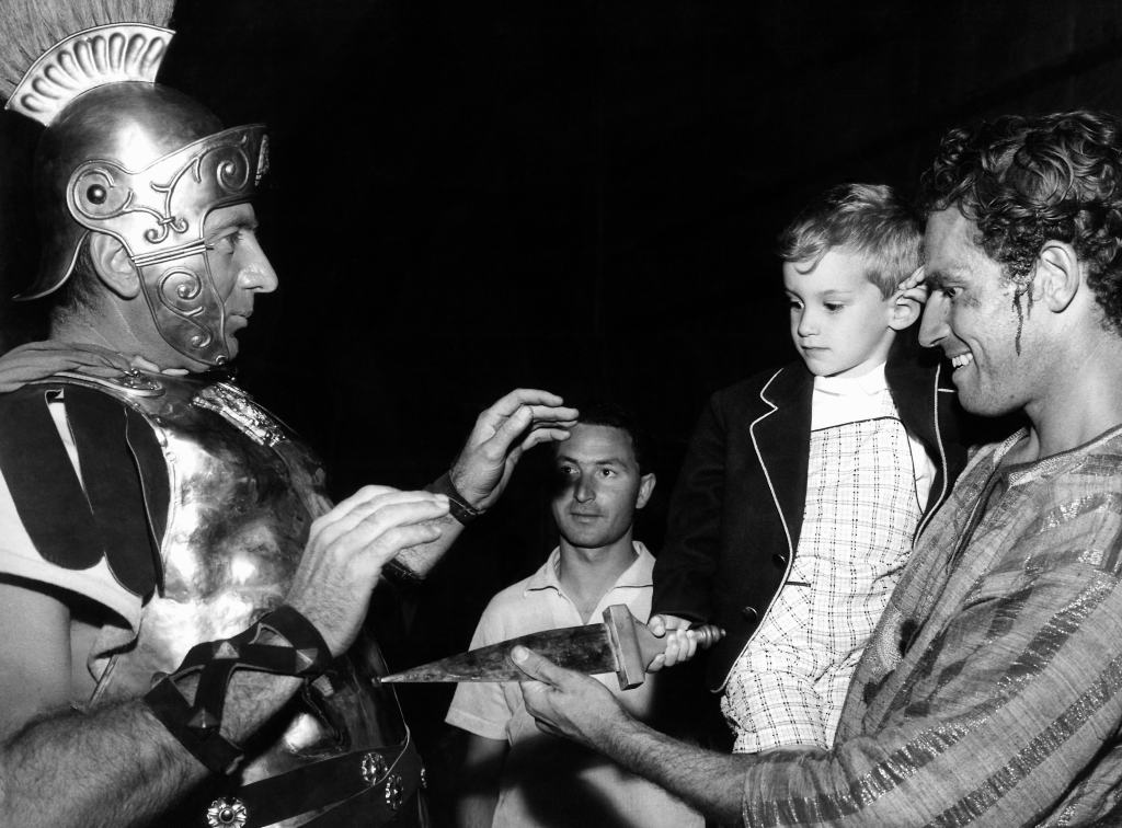BEN-HUR, Charlton Heston (right) holding son Fraser Heston on set, 1959