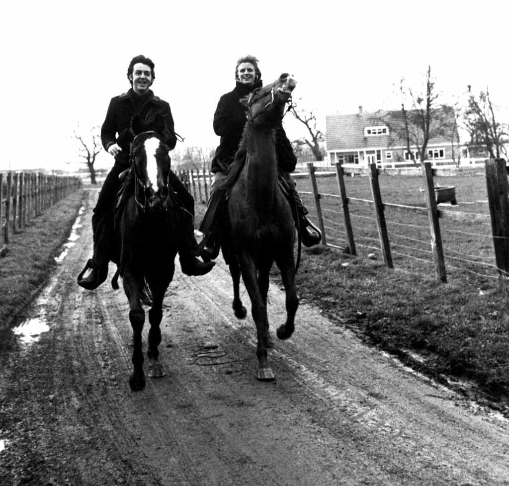Paul and Linda McCartney riding horses