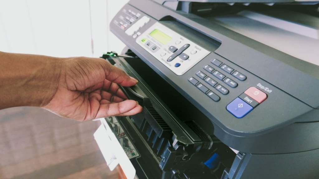 Woman Changes Ink Cartridge in Laser Printer