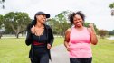 Two women smiling while walking outdoors using a free plan