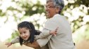 Woman playing with her granddaughter outdoors to help manage stress