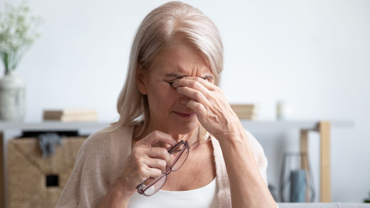 Woman pinching her eyes to help them stop watering