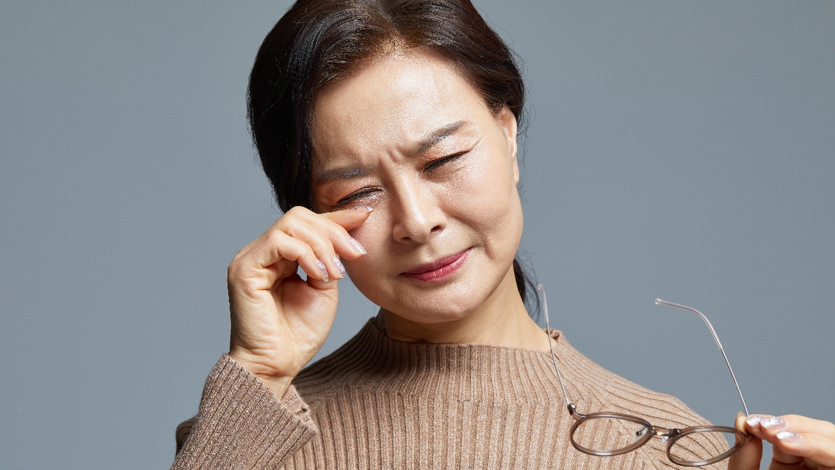 Woman rubbing her eye due to an ingrown eyelash