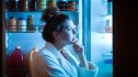 Woman looking in fridge to satisfy a late-night craving