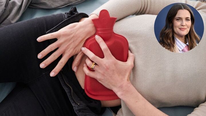 Close-up of a woman placing a hot water bottle on her abdomen to deal with menopause bloating; inset headshot of Drew Barrymore