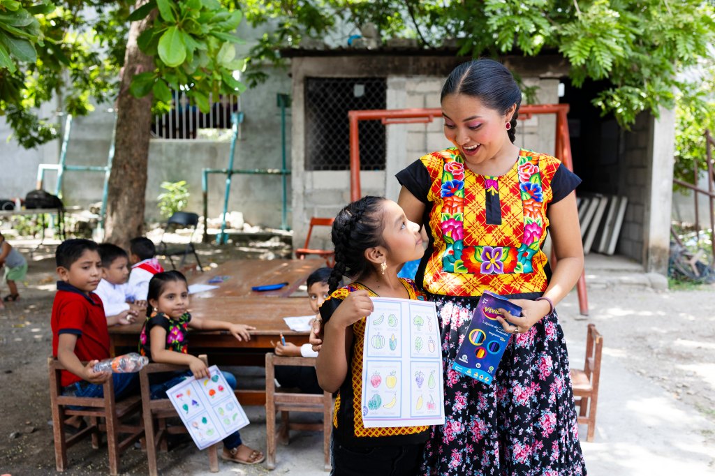 Children learning to color outside their homes.