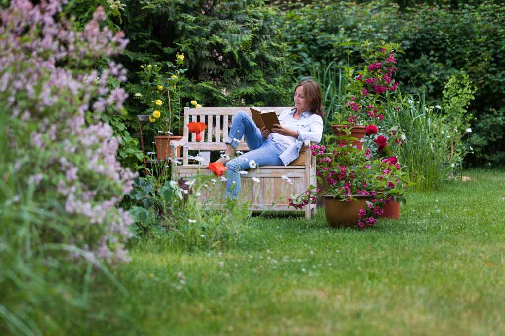 Woman relaxing on garden bench