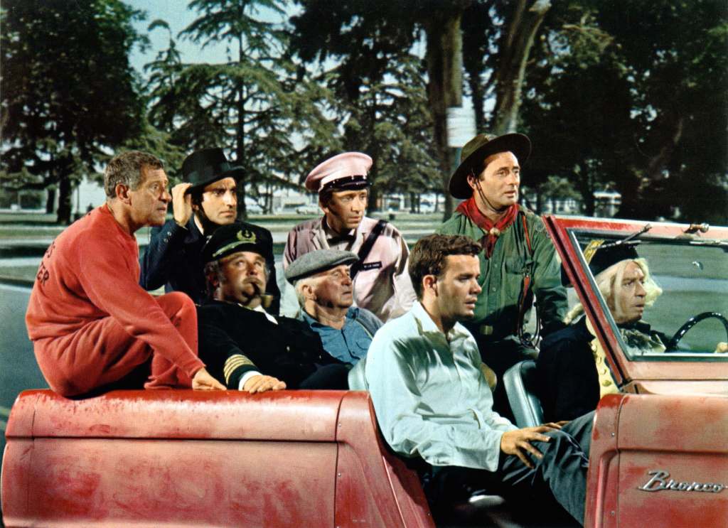 Milton Berle, Jamie Farr, Victor Buono, Jack Gilford, and Jim Hutton riding in a car in a lobby card from the film 'Who's Minding The Mint?', 1967. 