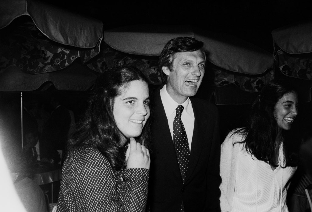 Alan Alda with his daughters, Elizabeth and Beatrice, at an outside event; circa 1970; New York.