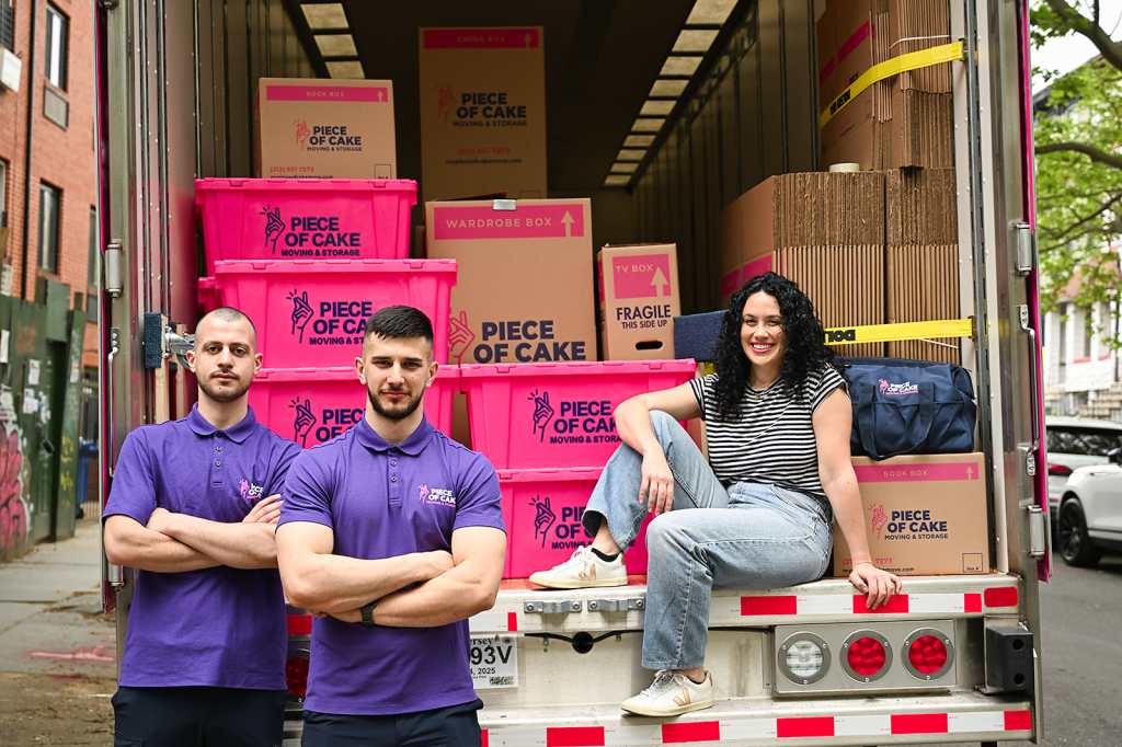 Woman posing in moving truck with Piece of Cake movers