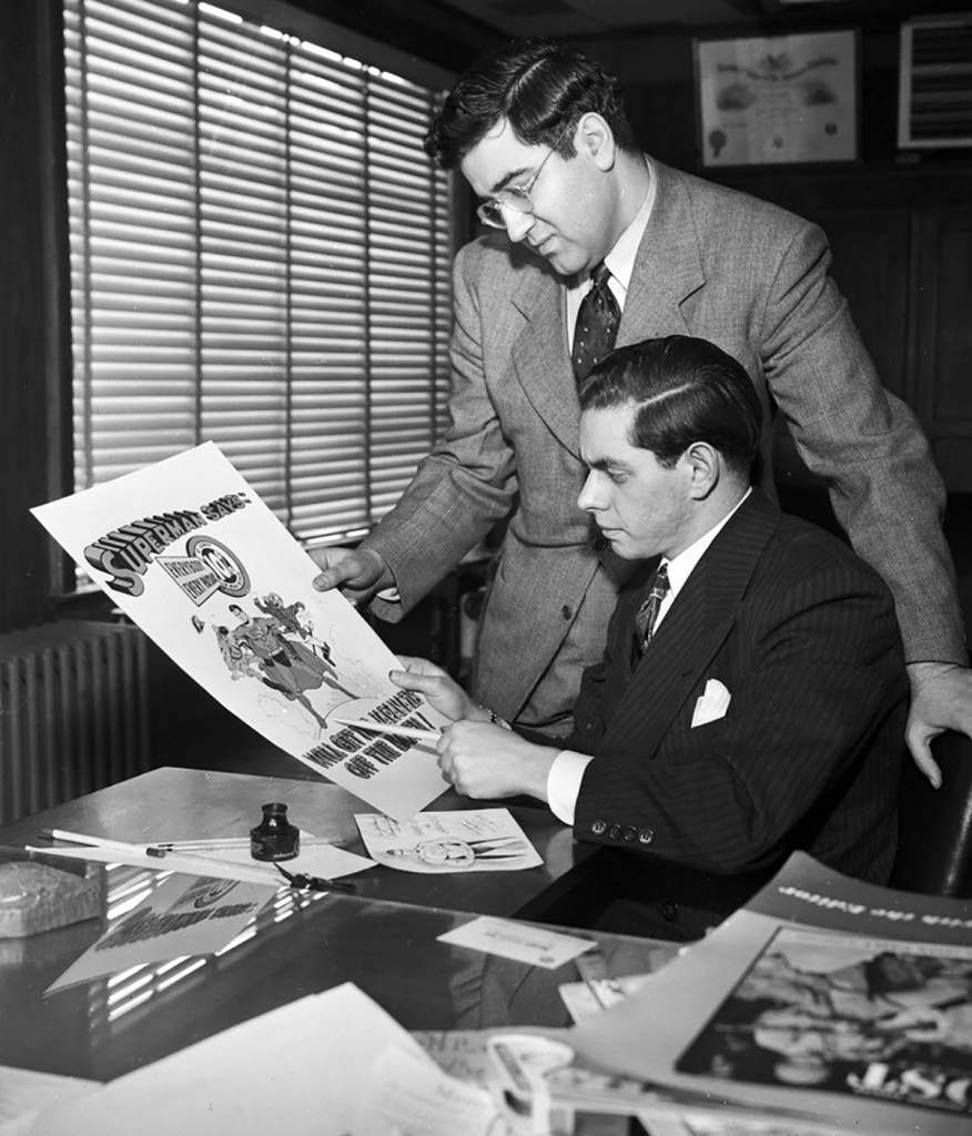 Jerry Siegel and Joe Shuster with a piece of Superman art.