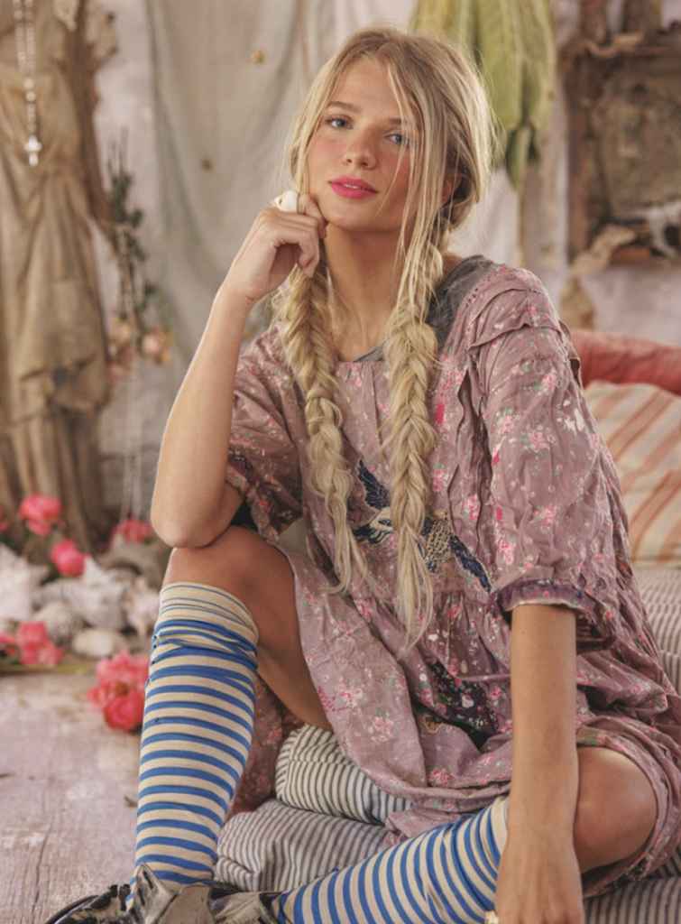 Magnolia Pearl garments showcasing layered textures, patchwork, and distressed fabrics, reflecting the brand’s focus on craftsmanship, storytelling, and resale value.