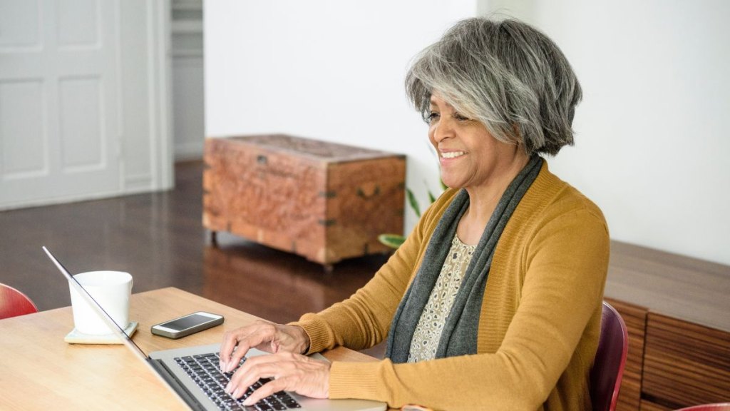 Senior African American woman using laptop smiling