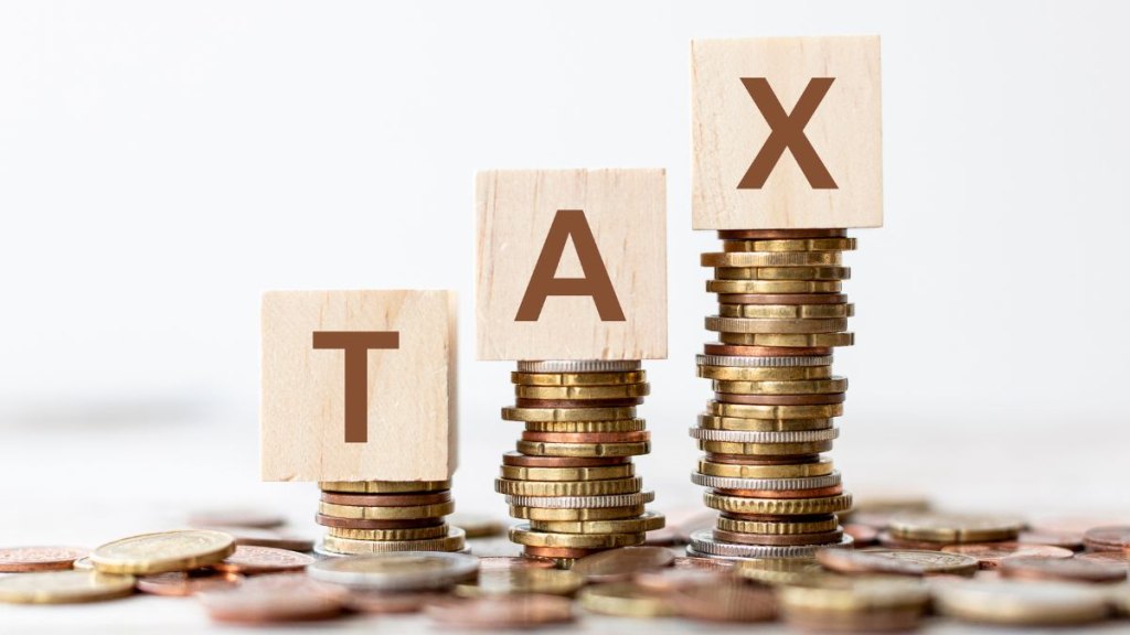 Tax wording on wooden cubes with coins