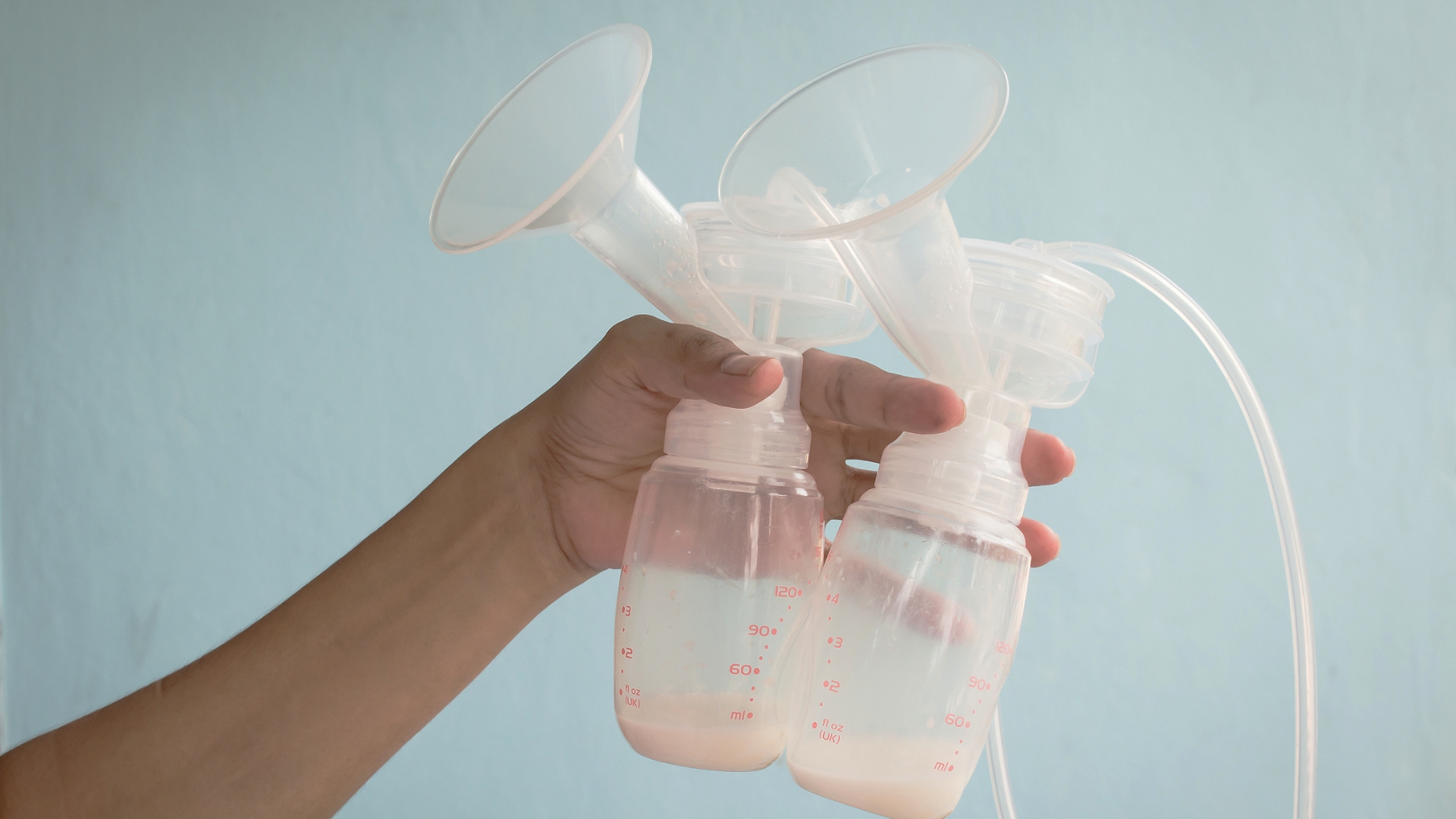 a wearable breast pump that fits inside her bra, allowing her to manage daily tasks while pumping comfortably and efficiently.