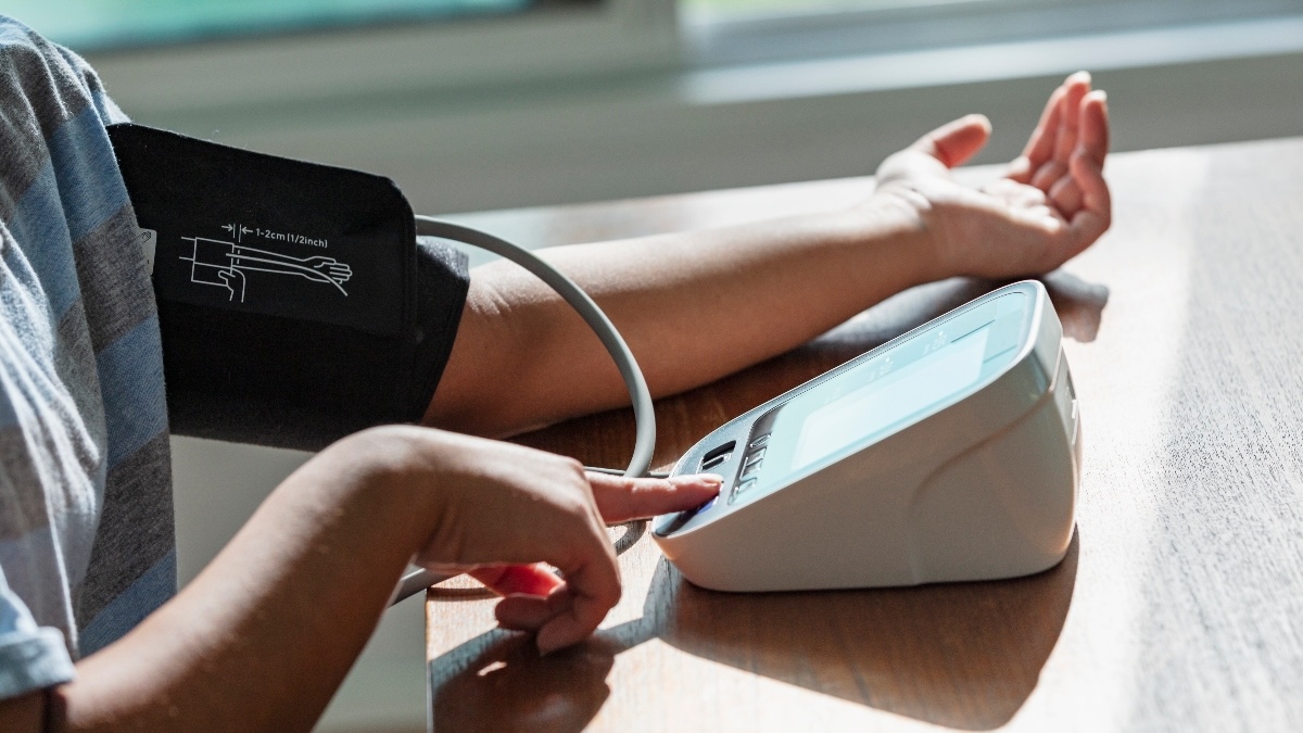Close-up of a woman measuring her blood pressure at home