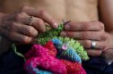 TOKYO, JAPAN - AUGUST 07: Thomas Daley of Team Great Britain is seen knitting before the Men's 10m Platform Final on day fifteen of the Tokyo 2020 Olympic Games at Tokyo Aquatics Centre on August 07, 2021 in Tokyo, Japan. (Photo by Clive Rose/Getty Images)