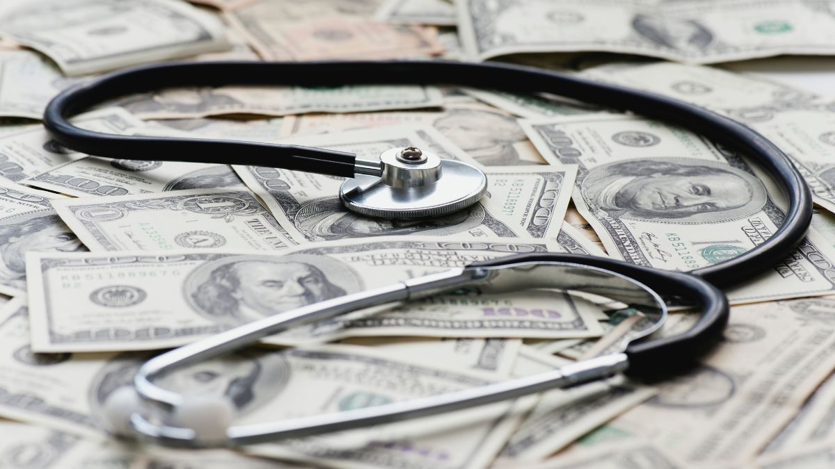 Stethscope on pile of US banknotes