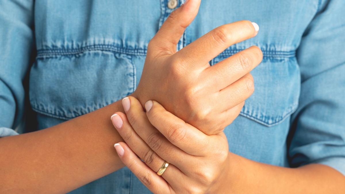 Close-up of a woman with arthritis rubbing her hands