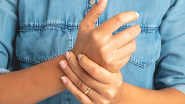Close-up of a woman with arthritis rubbing her hands