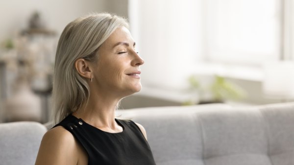 Older woman breathing deeply to activate her vagus nerve to clear her brain fog