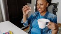 Middle-aged woman happily takes a supplement for brain health