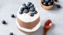A Greek yogurt parfait made with blueberries and chocolate, both foods that help boost dopamine in the brain